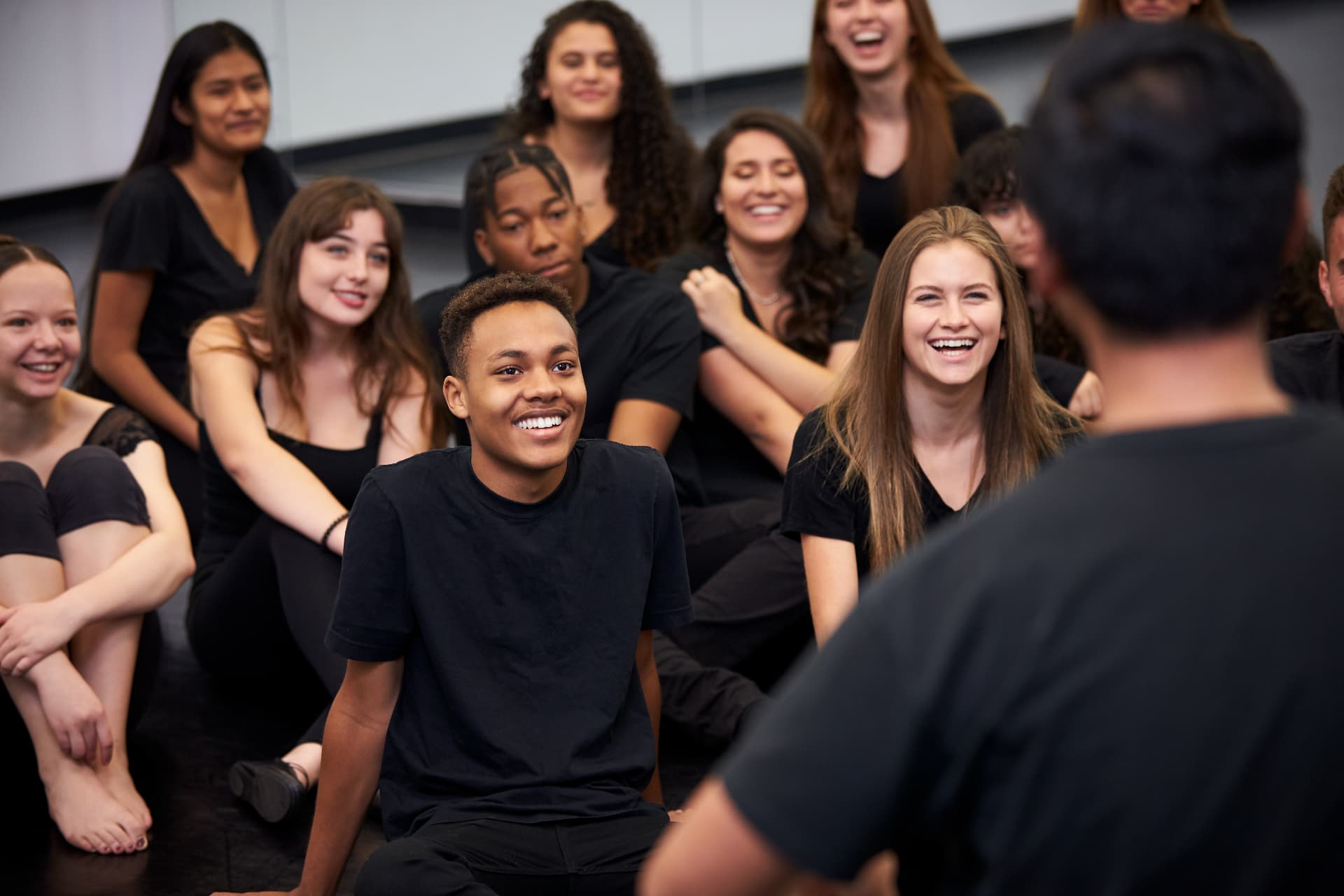 Aspiring actors laughing together during a workshop
